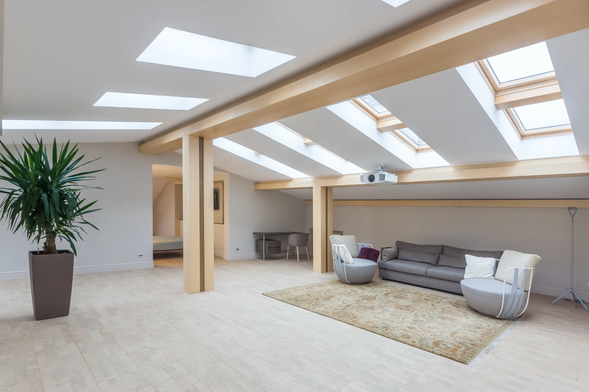Lumineux et spacieux, le grenier de la maison dispose d'un intérieur confortable, d'un agencement de bureau contemporain et d'une grande lumière naturelle grâce à de grandes fenêtres